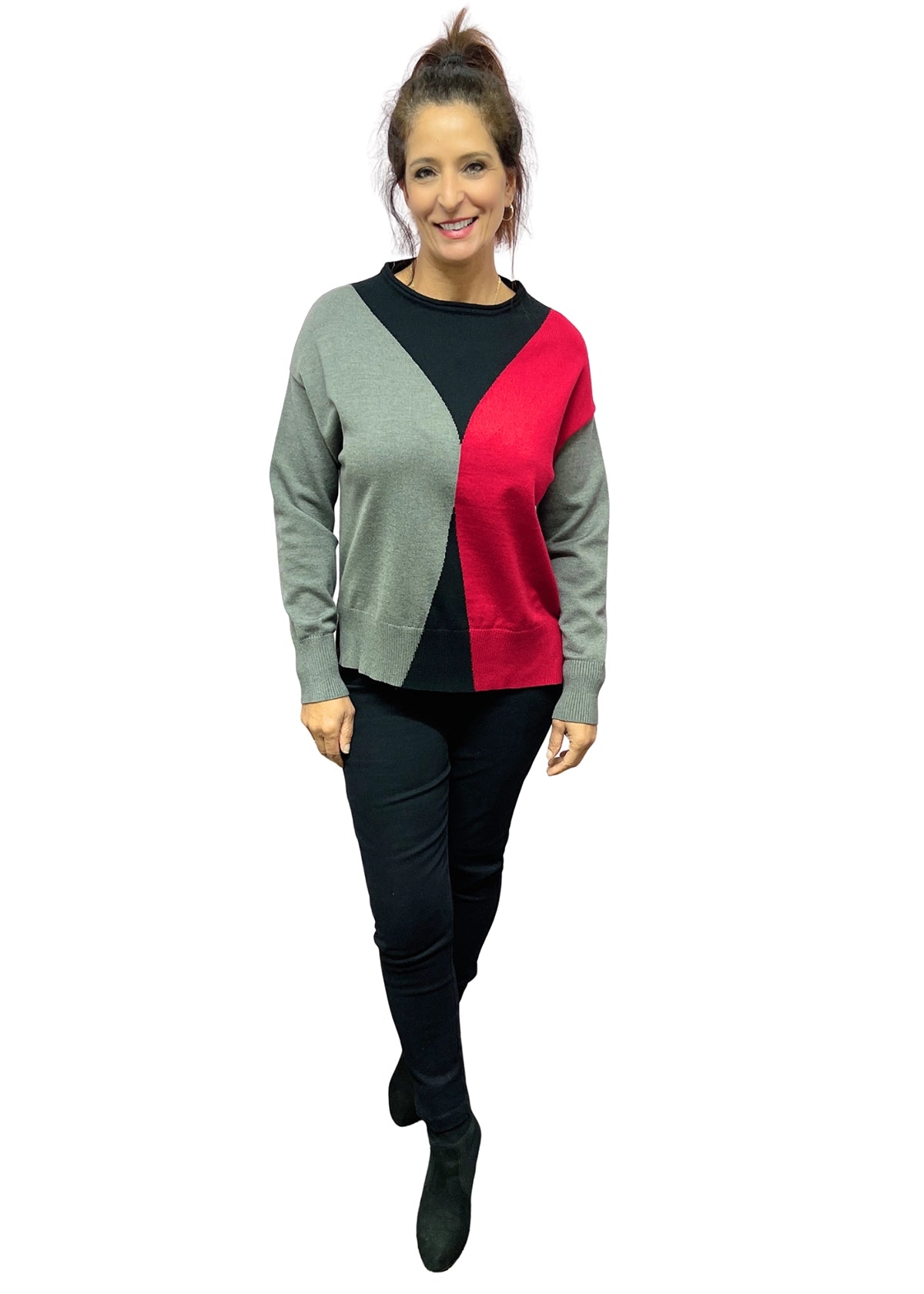 Woman wearing a color-blocked sweater with gray, black, and red sections on a white background.