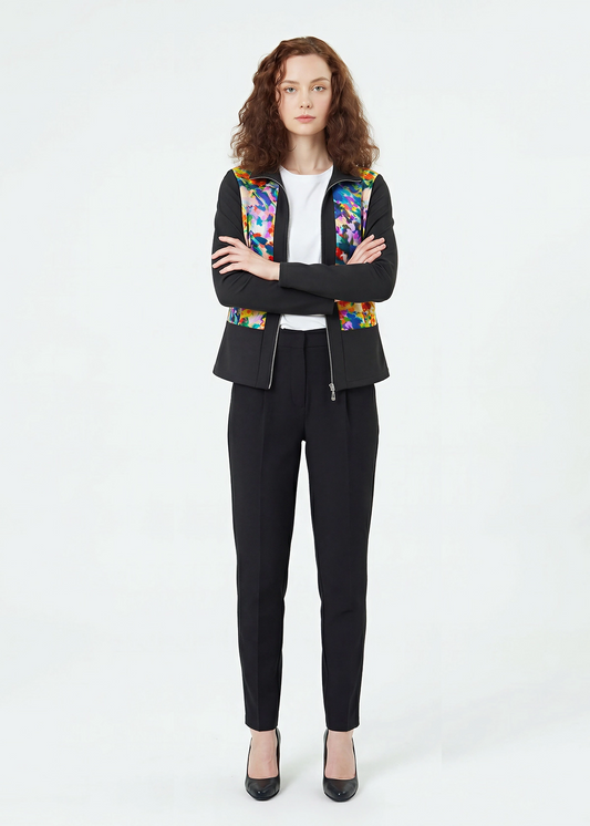 Woman wearing a black suit with a colorful floral pattern on a white background