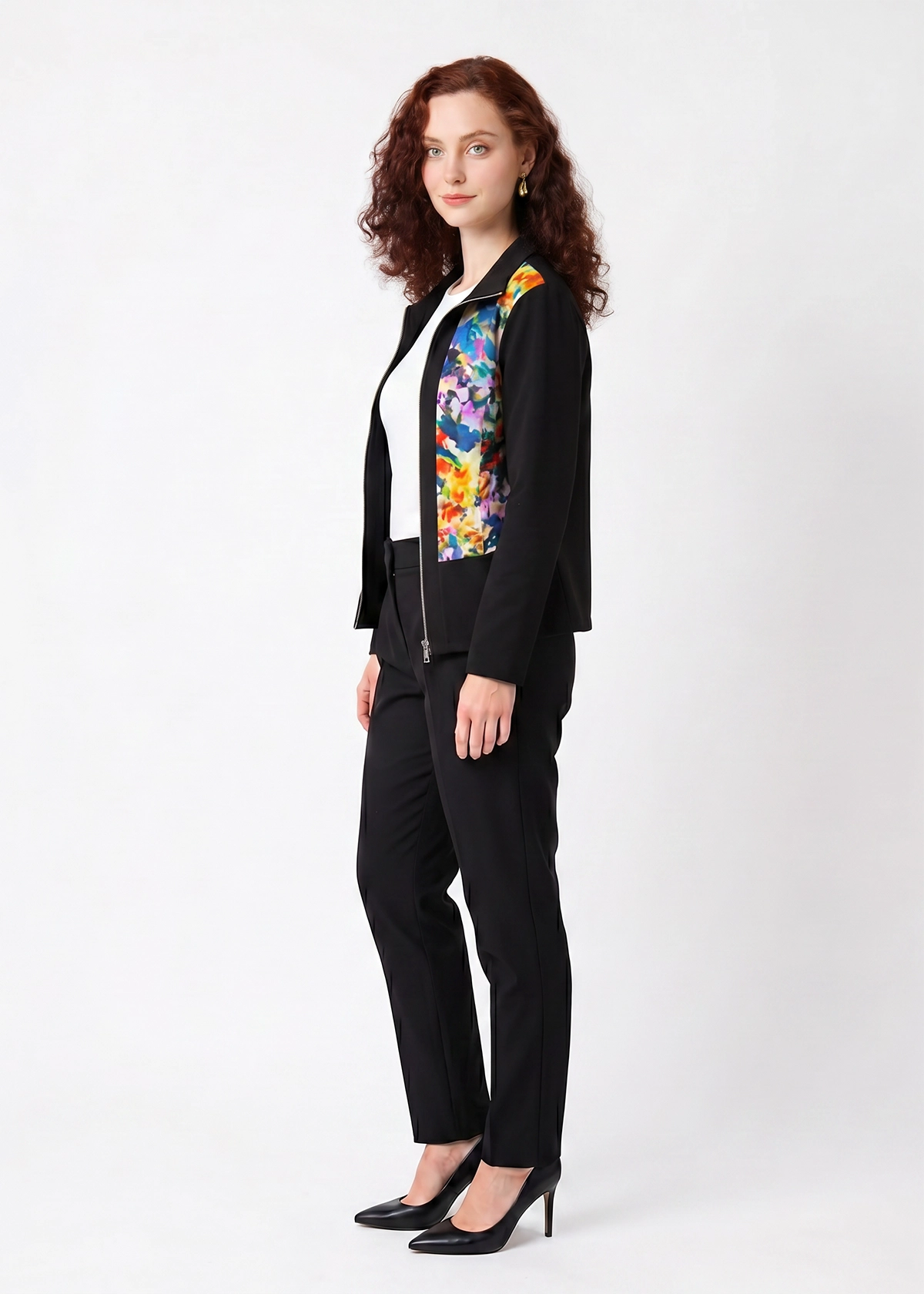 Woman wearing a black suit with a colorful floral pattern on a white background
