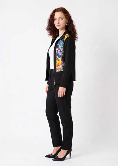 Woman wearing a black suit with a colorful floral pattern on a white background