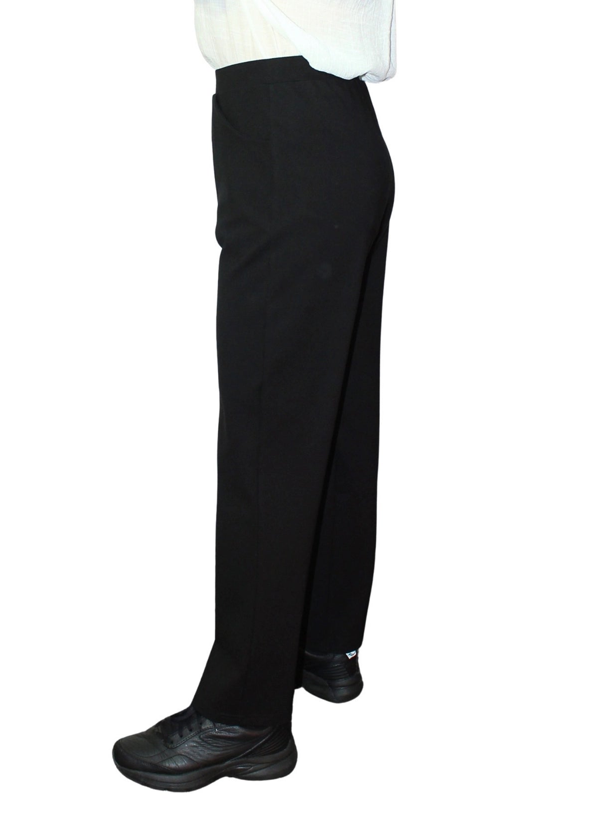 Black pants worn by a person on a white background