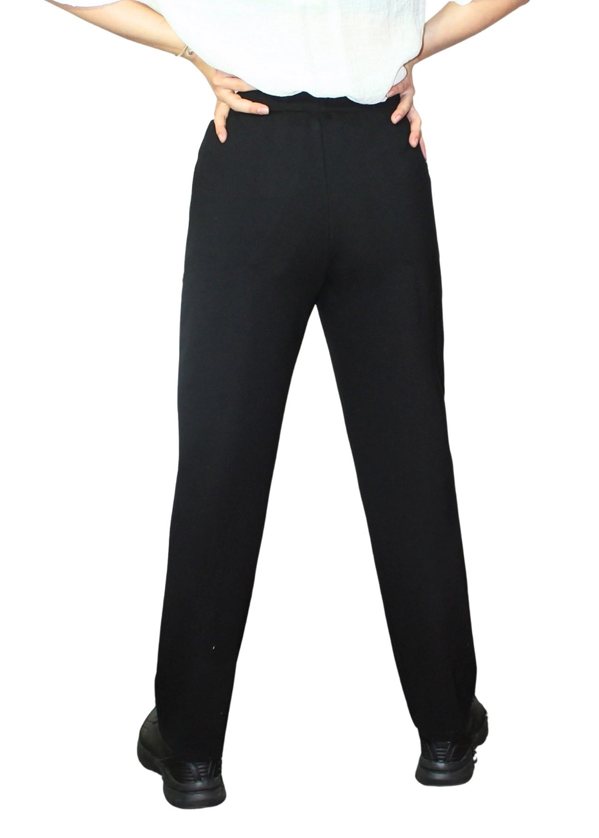 Person wearing black pants on a white background
