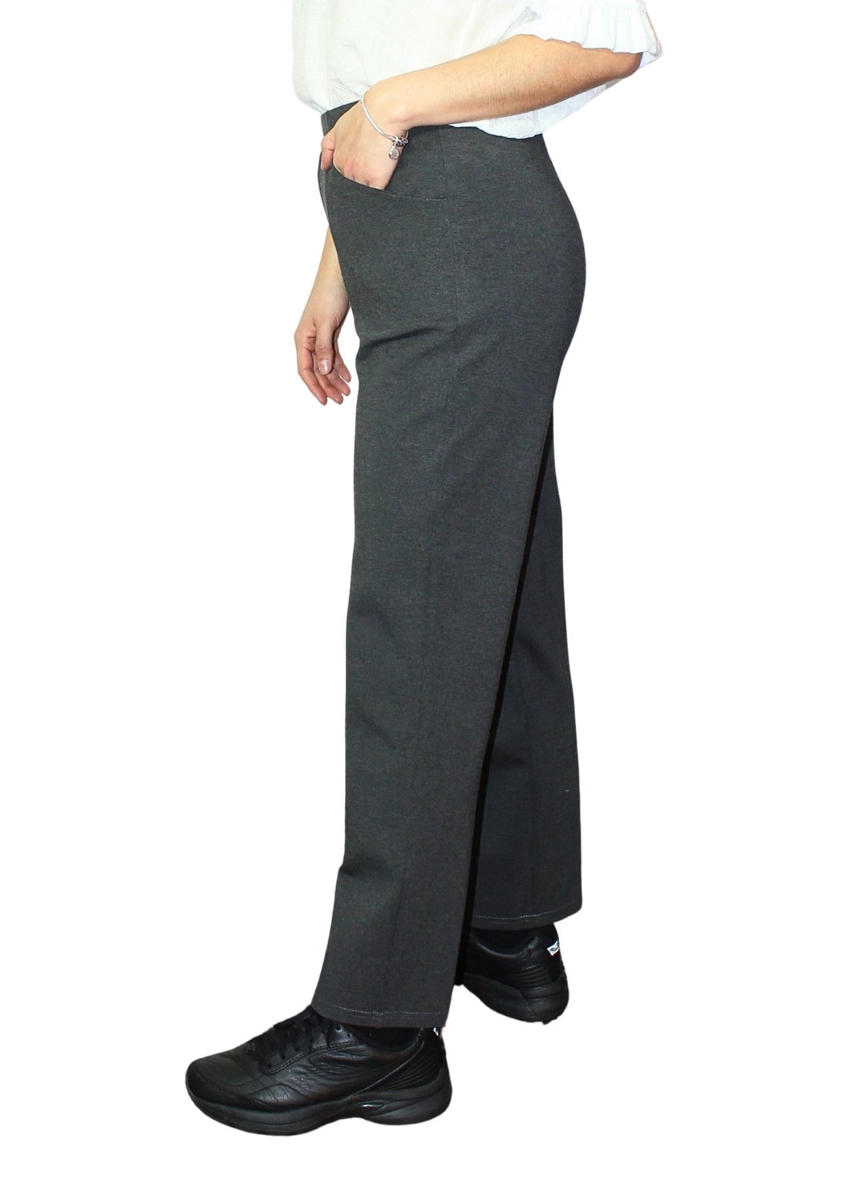 Person wearing a gray skirt with a white shirt on a white background