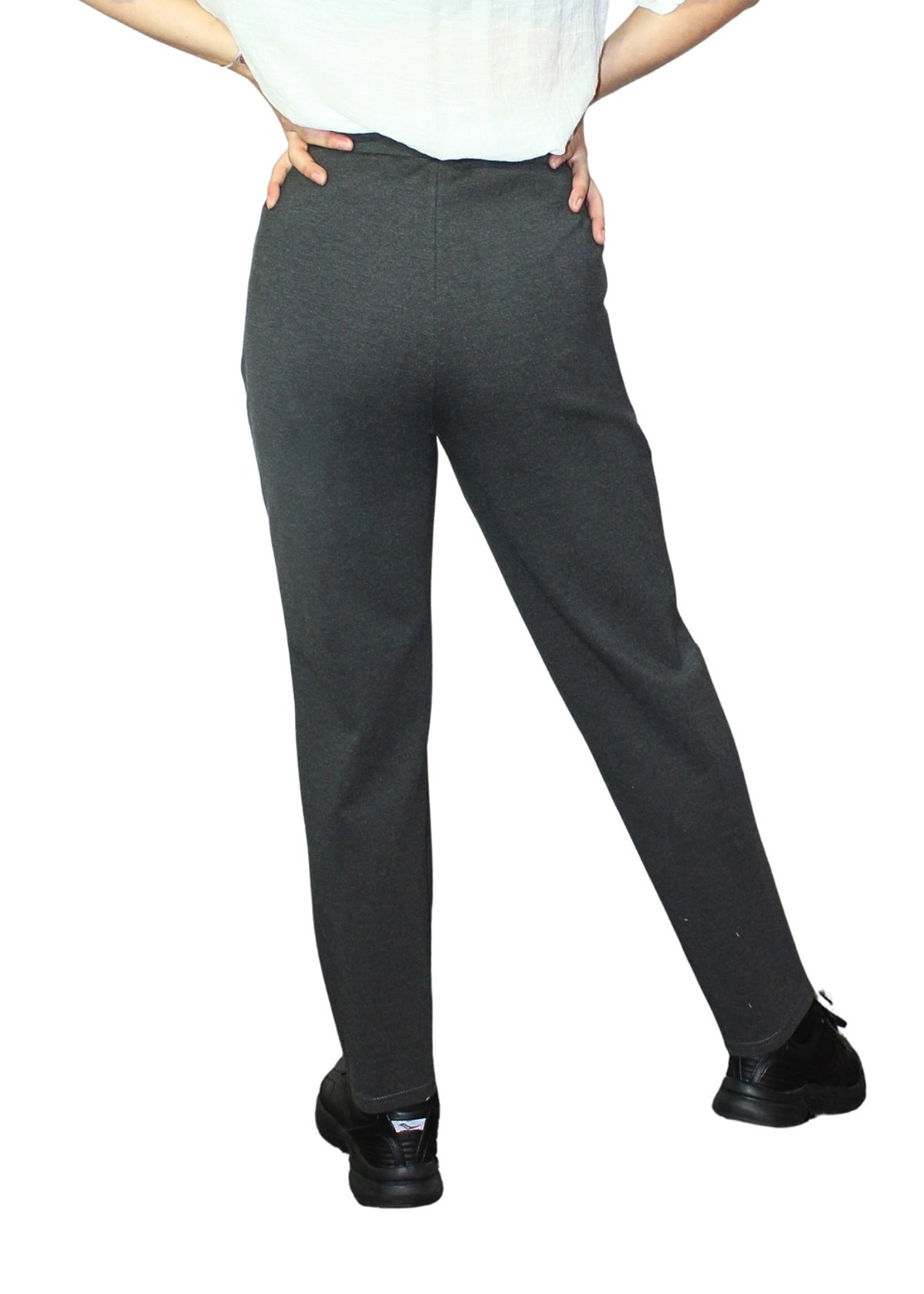 Person wearing dark gray pants on a white background