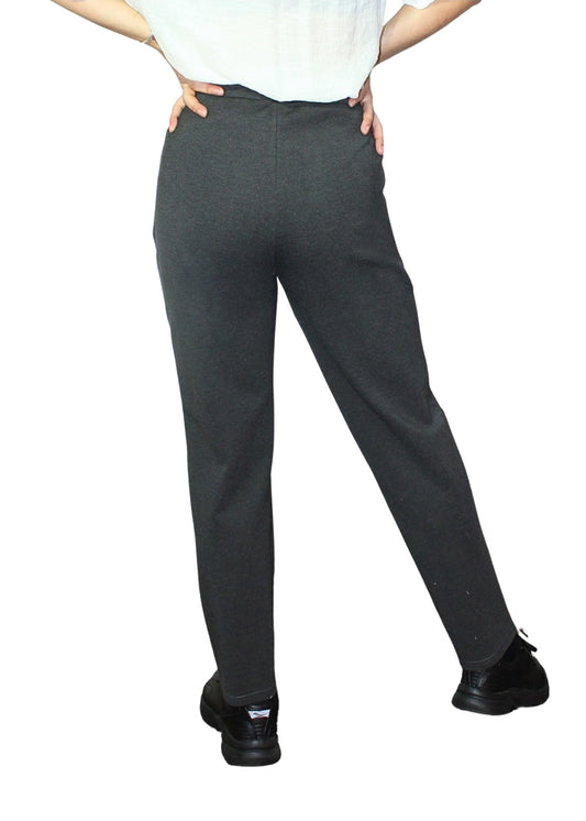 Person wearing dark gray pants on a white background