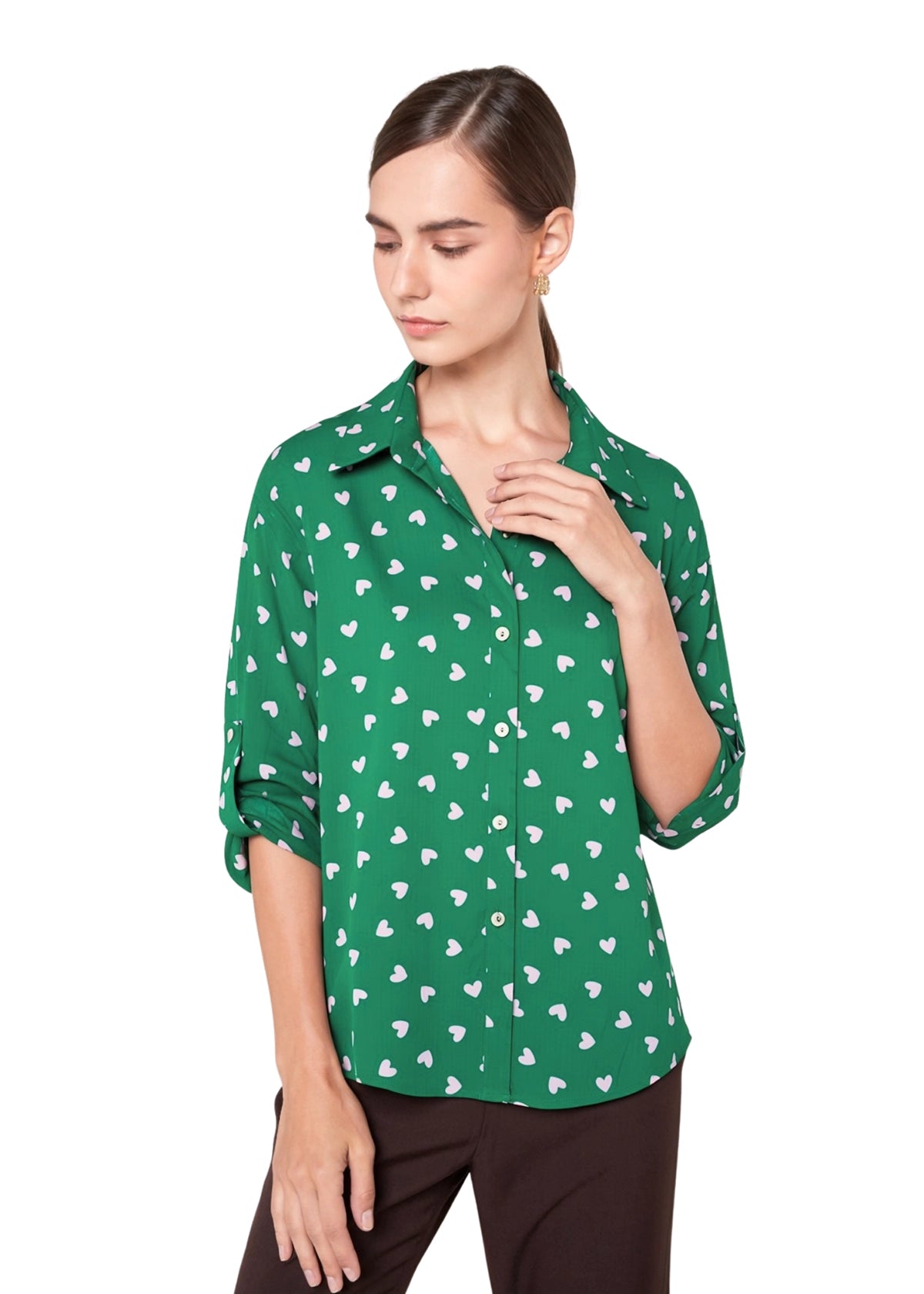 Woman wearing a green shirt with white pattern on a white background