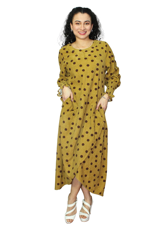 Woman wearing a yellow dress with brown polka dots on a white background