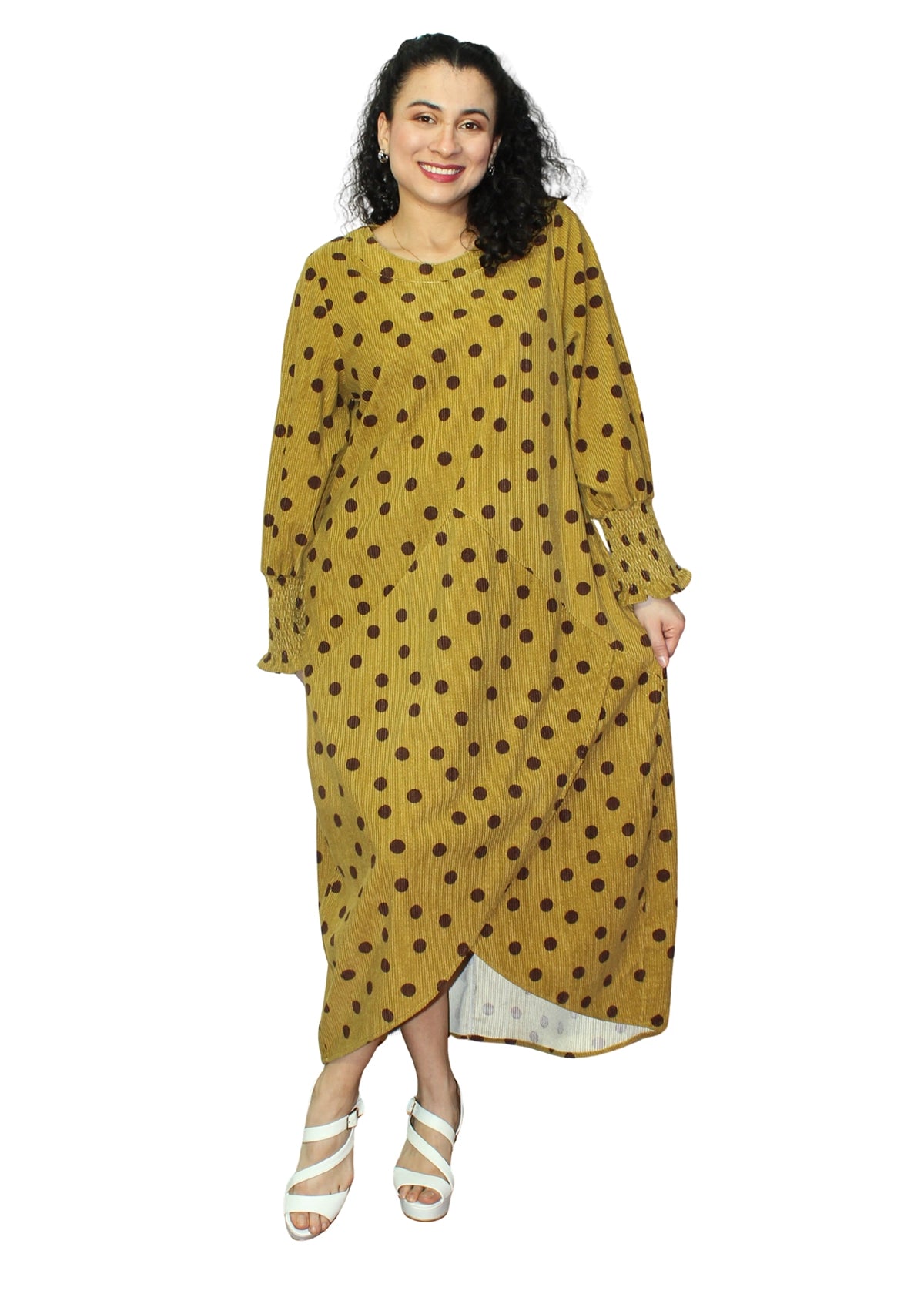 Woman wearing a yellow dress with brown polka dots on a white background