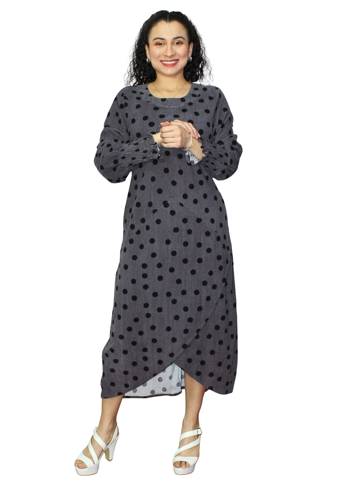 Woman wearing a gray polka dot dress on a white background