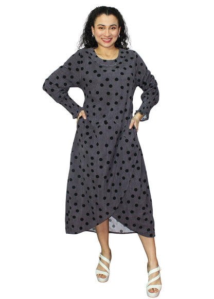 Woman wearing a gray dress with black polka dots on a white background