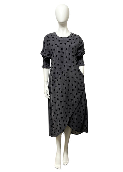 Black polka dot dress on a mannequin against a white background