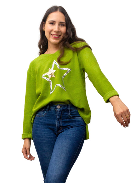 Woman wearing a green sweater with a star design on a white background