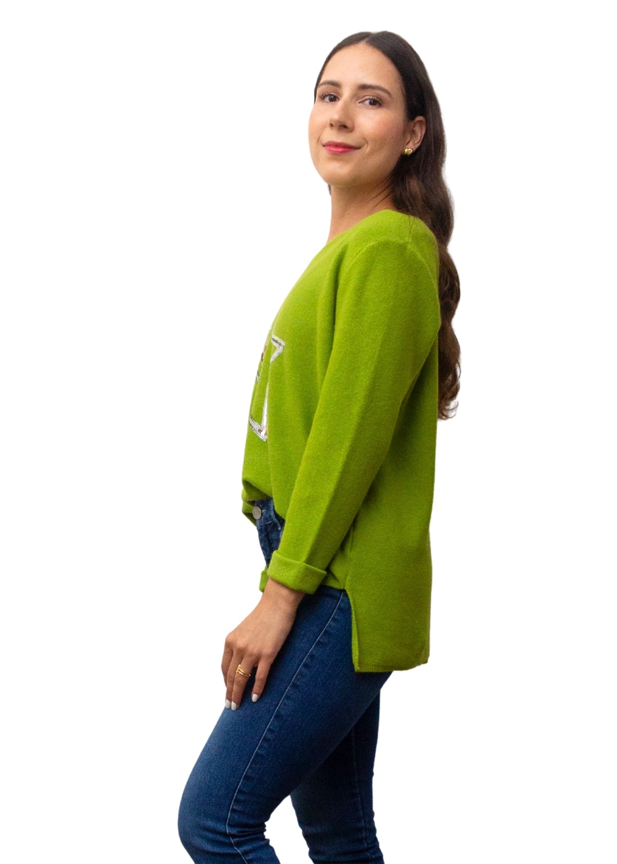 Woman wearing a green sweater and blue jeans on a white background