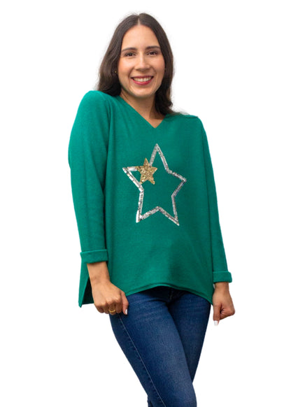 Woman wearing a green sweater with a star design on a white background
