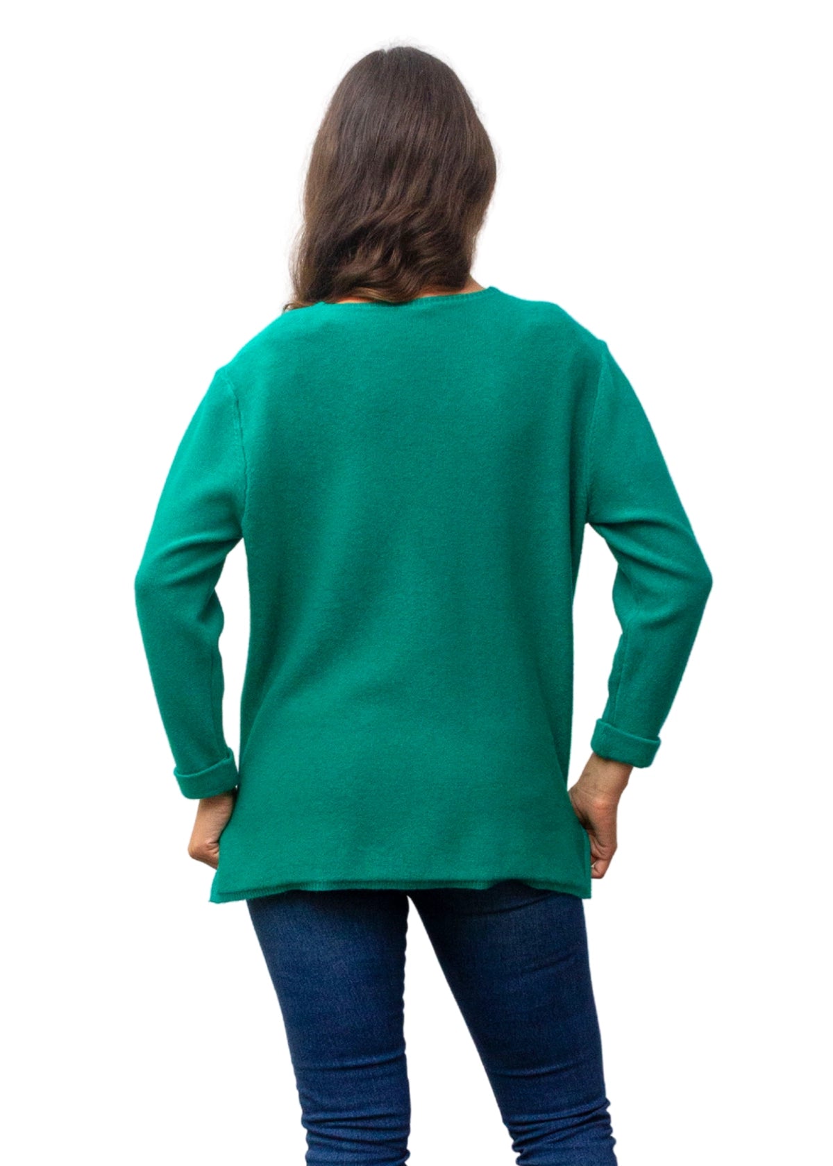 Person wearing a green sweater and blue jeans on a white background
