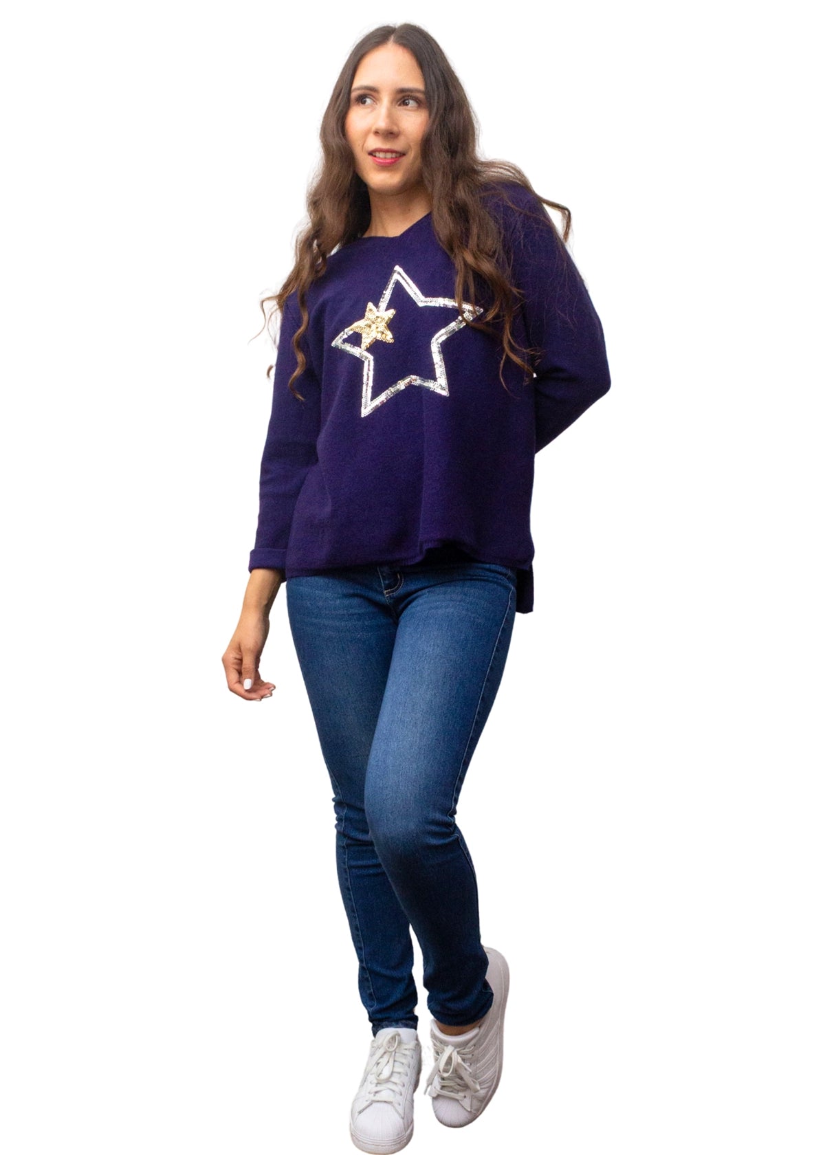 Woman wearing a purple sweater with a star design and blue jeans on a white background