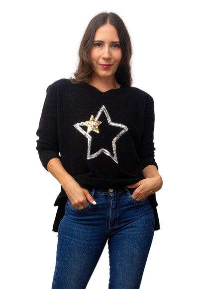Woman wearing a black sweater with a star design on a white background