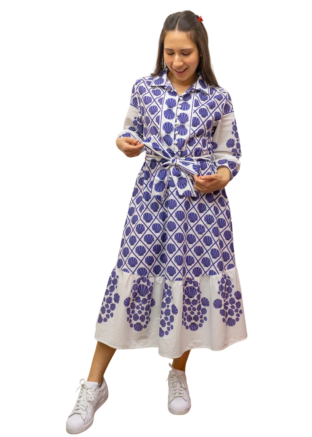 Woman wearing a blue and white patterned dress on a white background