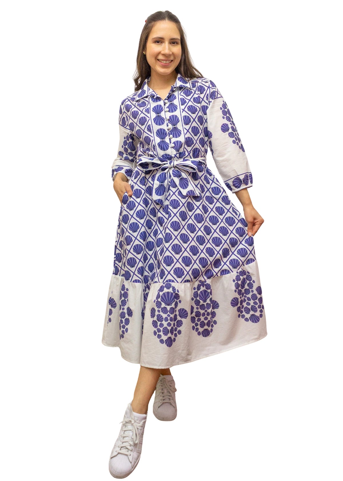 Woman wearing a blue and white patterned dress on a white background