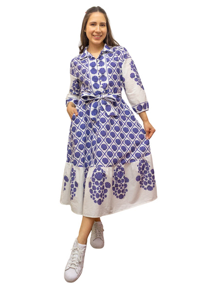 Woman wearing a blue and white patterned dress on a white background