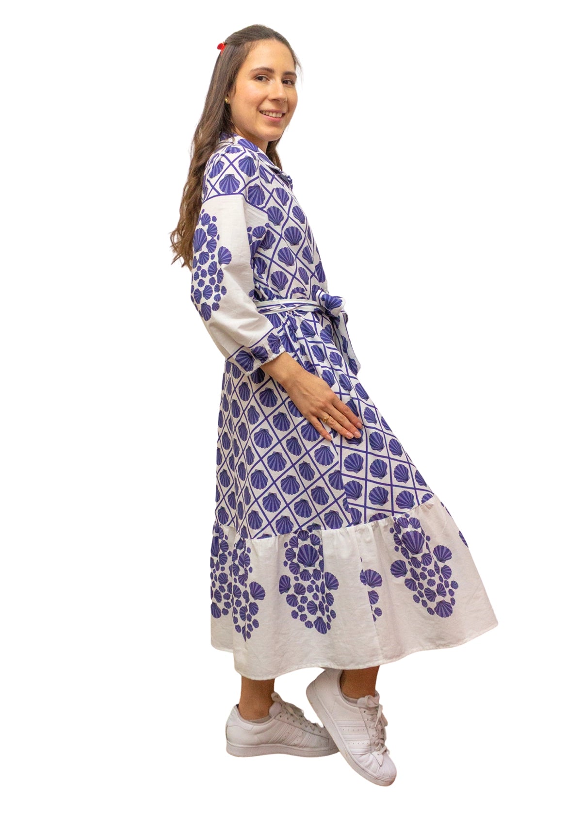 Woman wearing a blue and white patterned dress on a white background