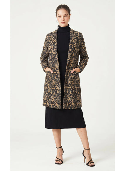 Woman wearing a leopard print coat on a white background