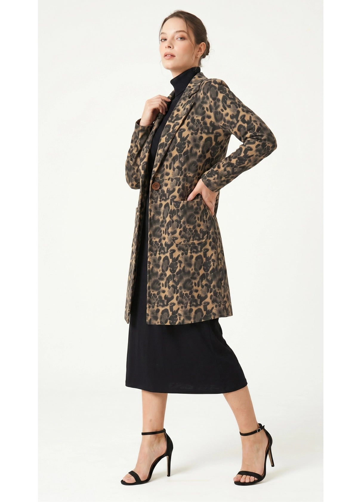 Woman wearing a leopard print coat on a white background