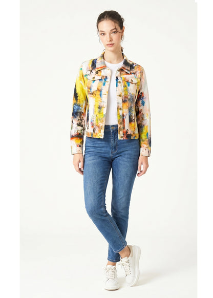 Woman wearing a colorful jacket and blue jeans on a white background