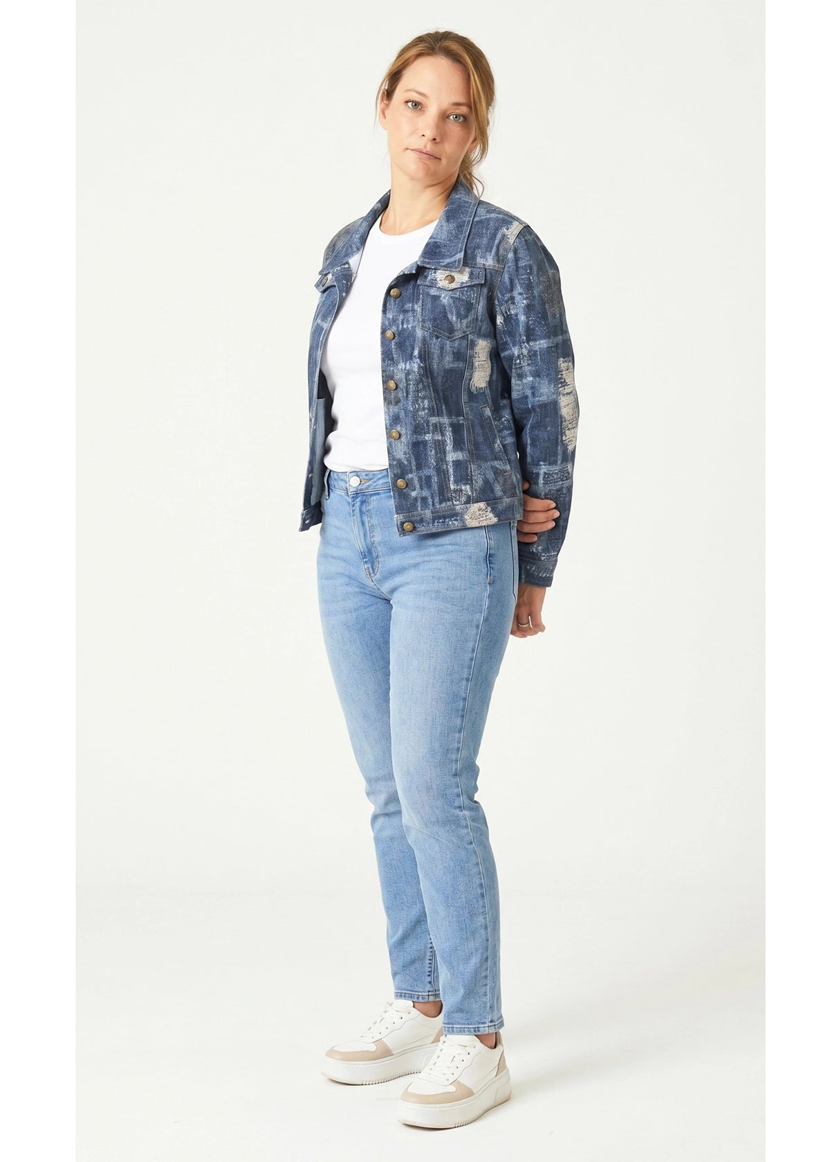 Woman wearing a blue denim jacket and jeans on a white background