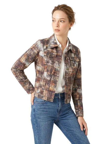 Woman wearing a plaid jacket and jeans on a white background