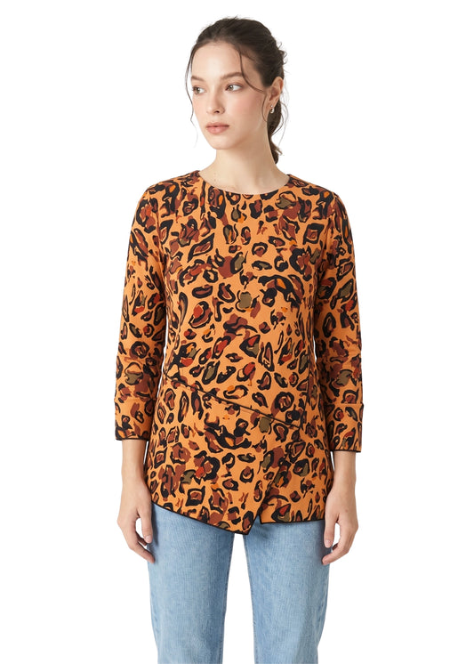 Woman wearing a leopard print top and light blue jeans on a white background