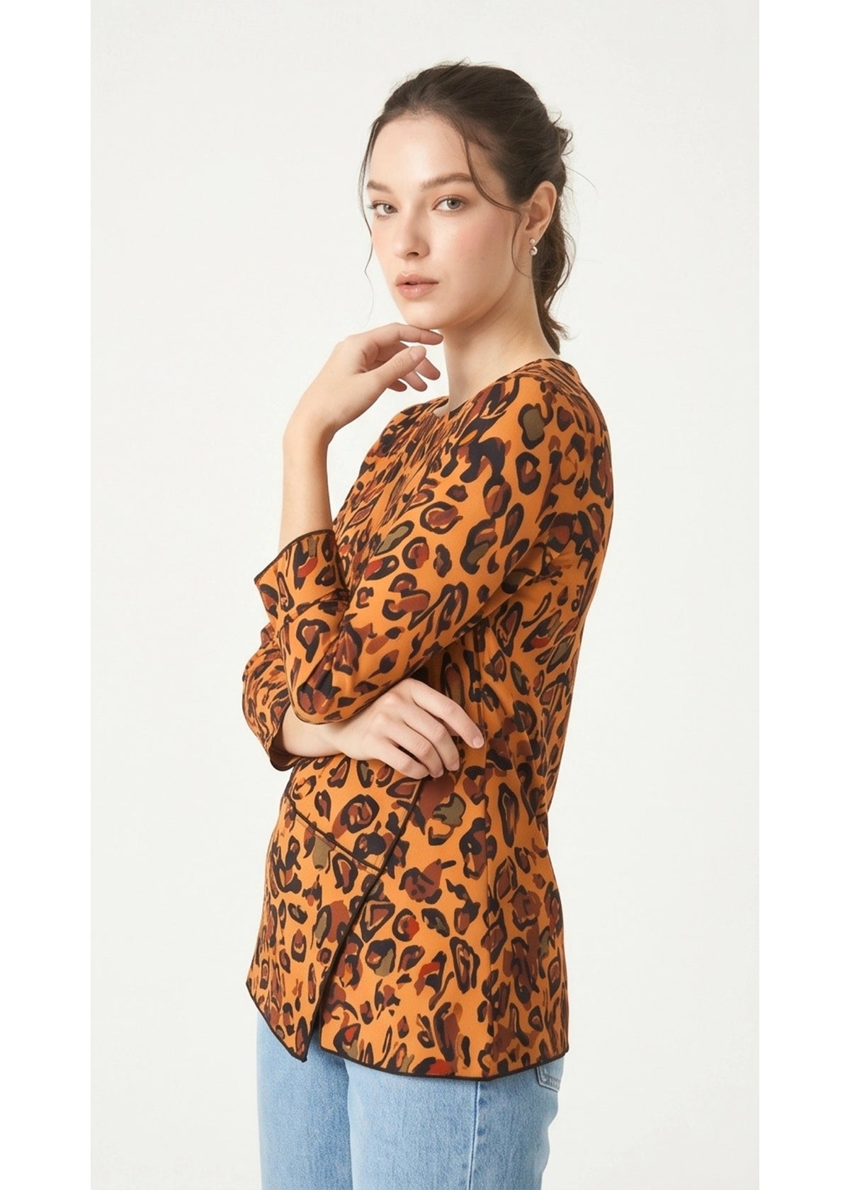 Woman wearing a leopard print blouse on a white background