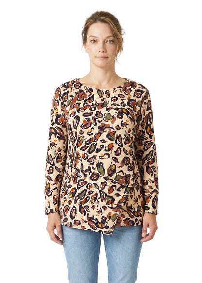 Woman wearing a long-sleeve top with a colorful pattern on a white background