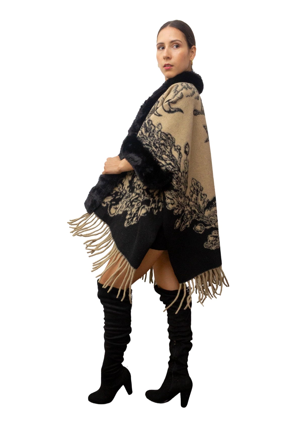 Woman wearing a black and beige patterned scarf with fringes on a white background